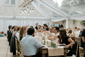 clear wedding tent with guests at sit down dinner