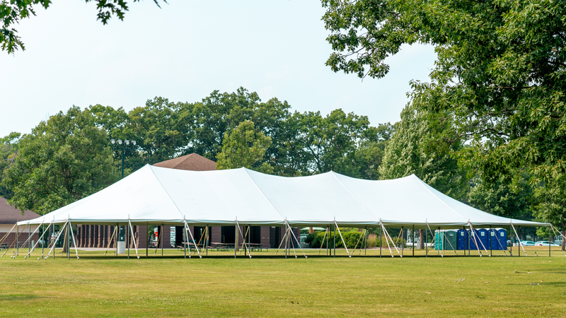 pole tent setup at a park